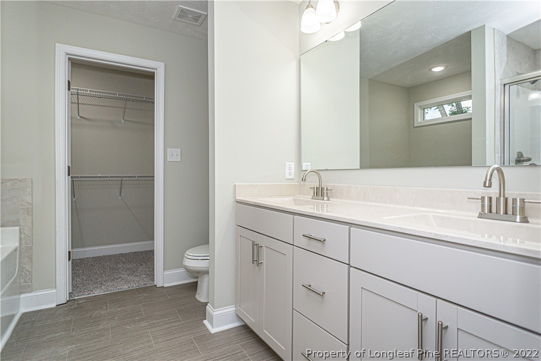 1628 Strickland Bridge Road Fayetteville, NC 28304 - Photo 20 of 34 a bathroom with a sink and a toilet
