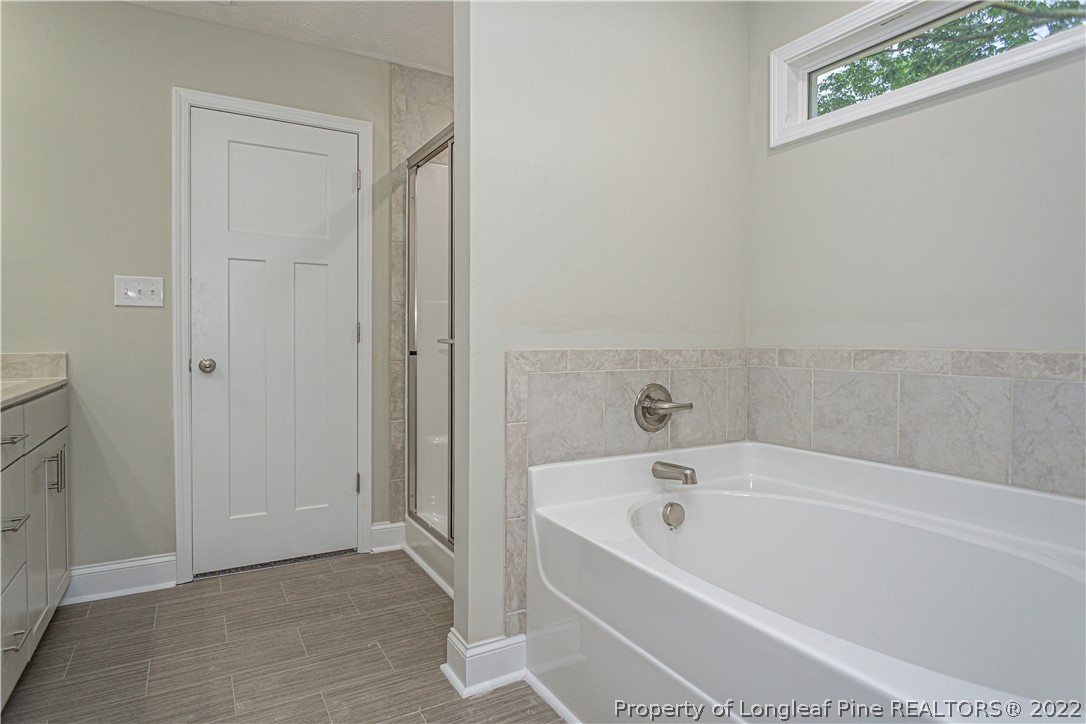 1628 Strickland Bridge Road Fayetteville, NC 28304 - Photo 21 of 34 a white bath tub sitting in a bathroom