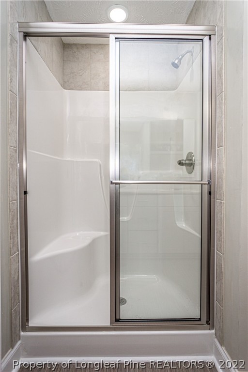 1628 Strickland Bridge Road Fayetteville, NC 28304 - Photo 23 of 34 a bathroom with a glass shower door