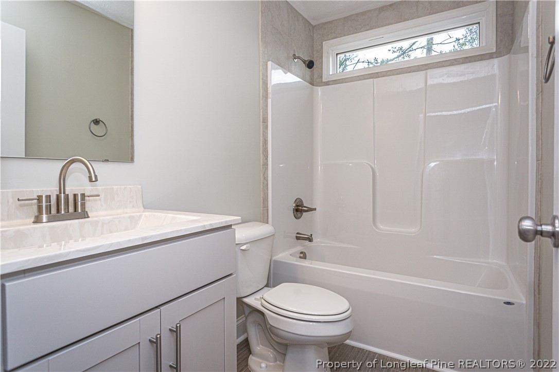 1628 Strickland Bridge Road Fayetteville, NC 28304 - Photo 26 of 34 a bathroom with a sink a toilet and shower