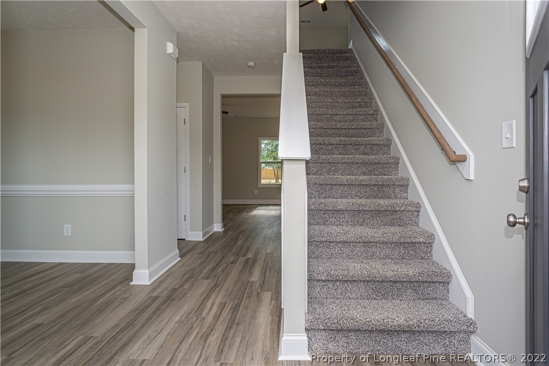 1628 Strickland Bridge Road Fayetteville, NC 28304 - Photo 5 of 34 a view of staircase with white walls and railing
