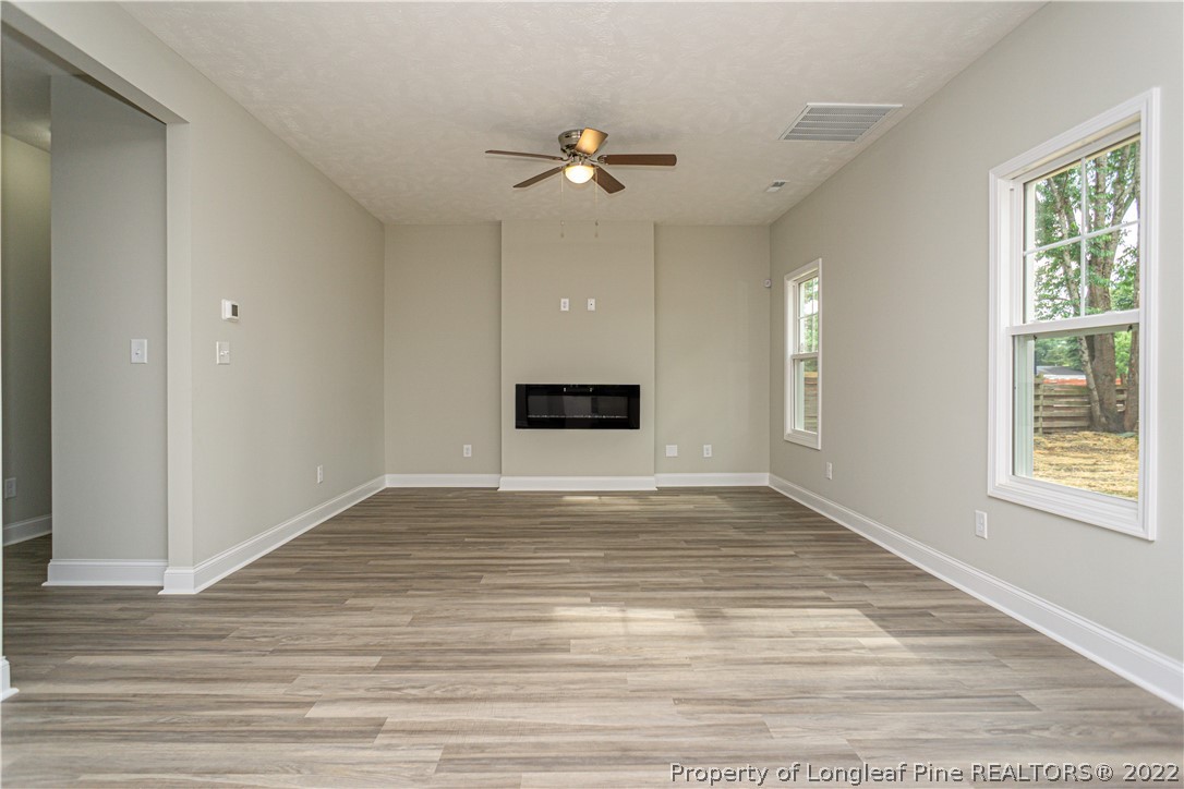 1628 Strickland Bridge Road Fayetteville, NC 28304 - Photo 10 of 34 a view of a livingroom with a ceiling fan and window