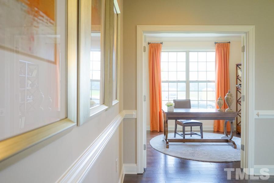 7709 Stonehenge Farm Lane Raleigh, NC 27613 - Photo 12 of 24 a view of a livingroom with furniture wooden floor and a window