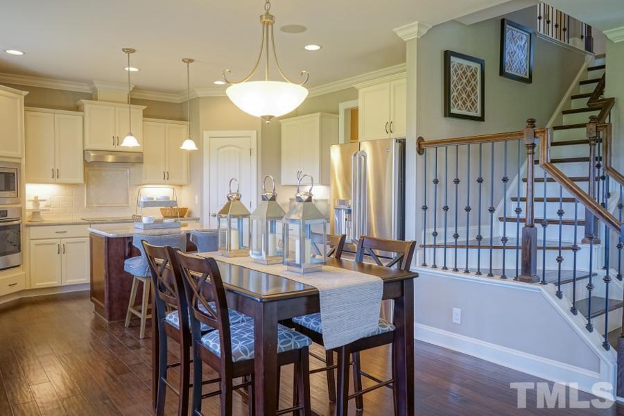 7709 Stonehenge Farm Lane Raleigh, NC 27613 - Photo 13 of 24 a large kitchen with a table and chairs