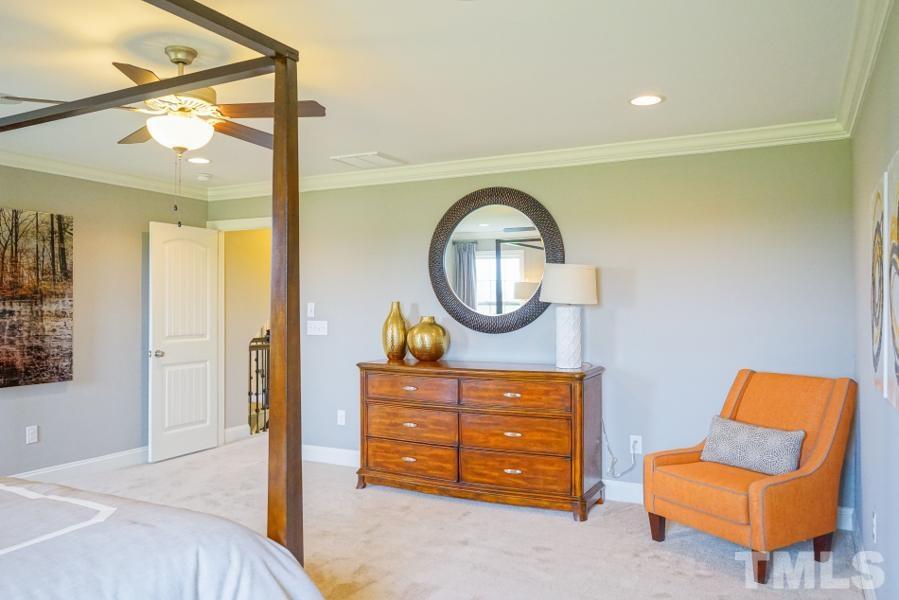 7709 Stonehenge Farm Lane Raleigh, NC 27613 - Photo 14 of 24 a living room with furniture and a mirror