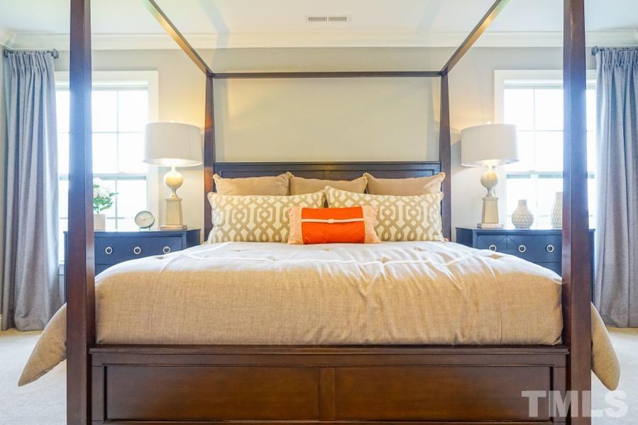 7709 Stonehenge Farm Lane Raleigh, NC 27613 - Photo 16 of 24 a bed sitting in a bedroom next to a window