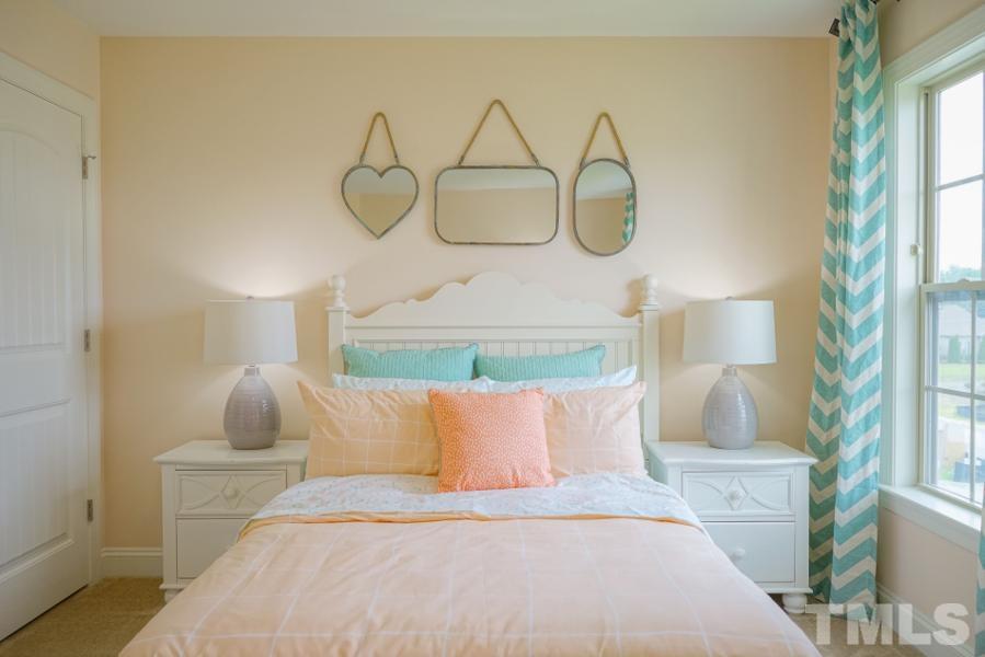 7709 Stonehenge Farm Lane Raleigh, NC 27613 - Photo 19 of 24 a bedroom with a bed and window
