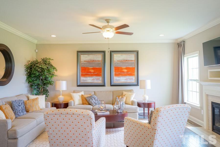 7709 Stonehenge Farm Lane Raleigh, NC 27613 - Photo 3 of 24 a living room with furniture and a large window