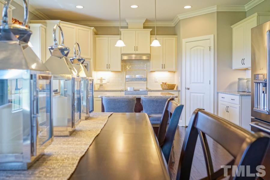 7709 Stonehenge Farm Lane Raleigh, NC 27613 - Photo 5 of 24 a large kitchen with a table and chairs