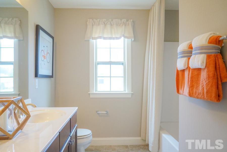 7709 Stonehenge Farm Lane Raleigh, NC 27613 - Photo 6 of 24 a view of a room that has a bed and a window in it