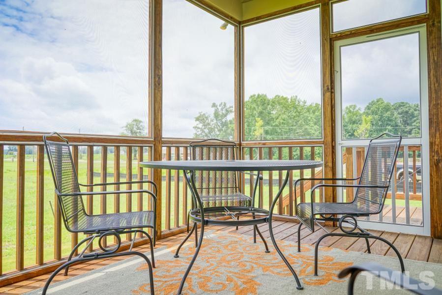 7709 Stonehenge Farm Lane Raleigh, NC 27613 - Photo 9 of 24 a view of a chairs and table in the balcony