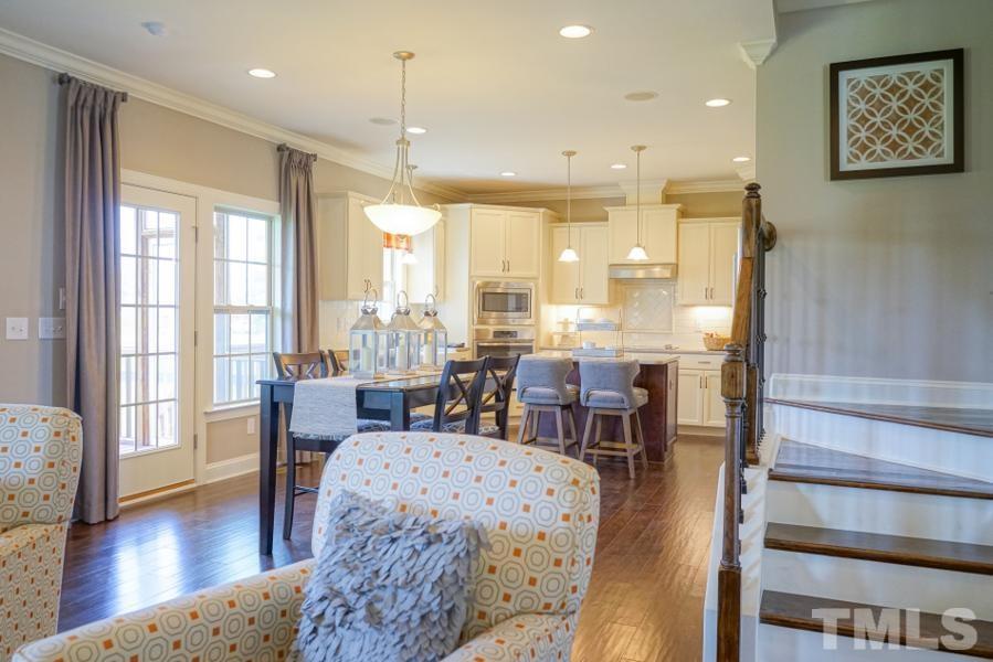 7709 Stonehenge Farm Lane Raleigh, NC 27613 - Photo 10 of 24 a view of a a dining room with furniture window and wooden floor