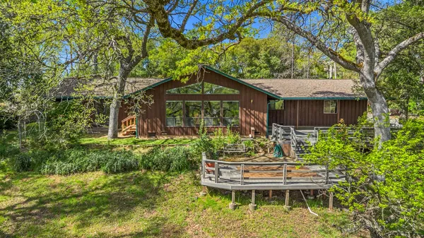 a backyard of a house with yard table and chairs