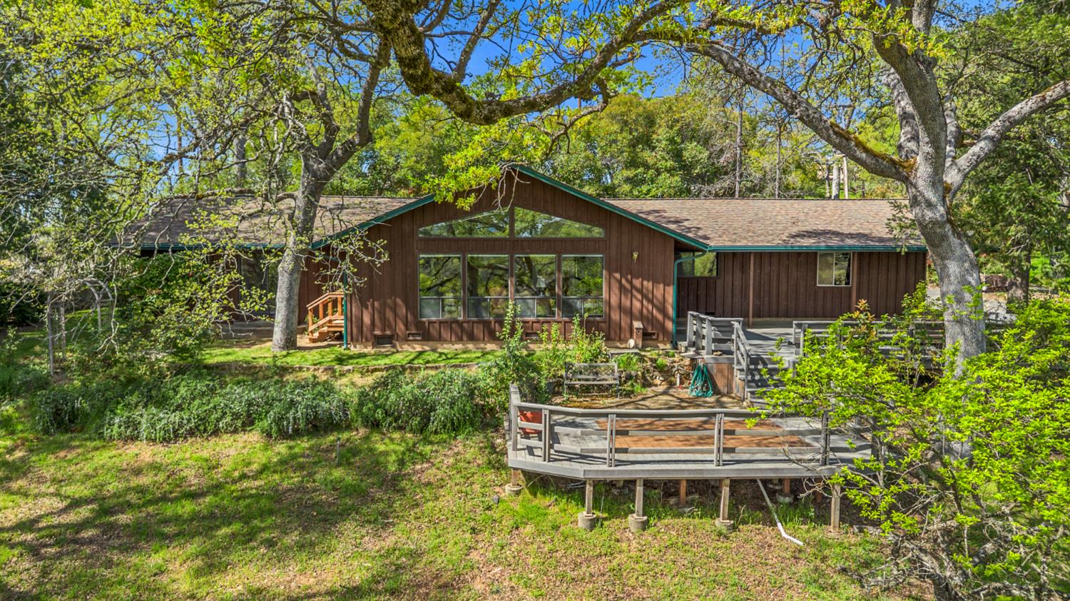 a backyard of a house with yard table and chairs
