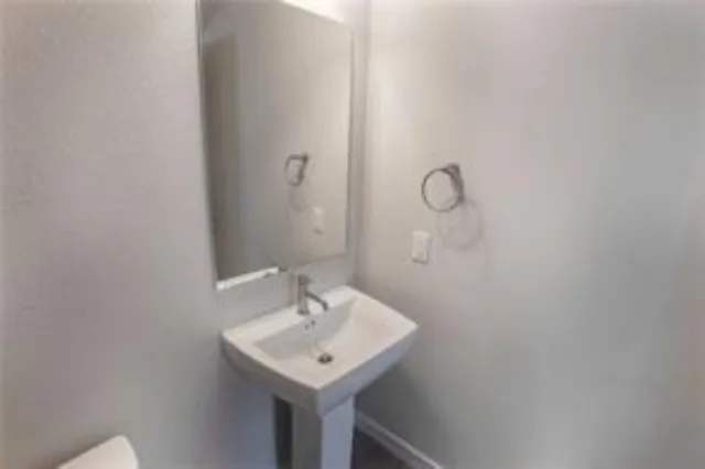 a bathroom with a sink a mirror and shower