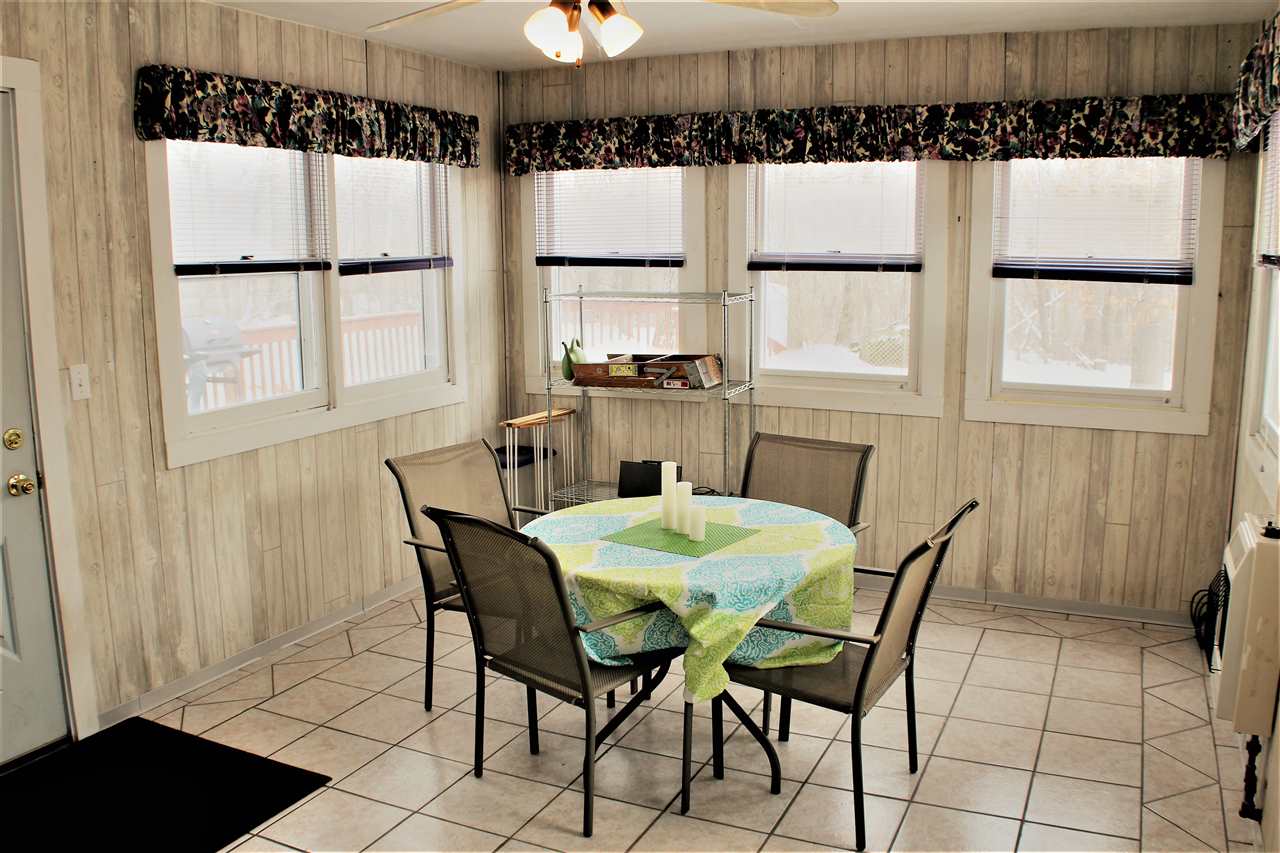 10619 Grover Oaks Road Roscoe, IL 61073 - Photo 12 of 24 a dining room with furniture a window and a chandelier