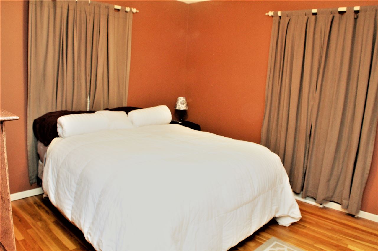 10619 Grover Oaks Road Roscoe, IL 61073 - Photo 15 of 24 a bed sitting in a bedroom next to a wooden door