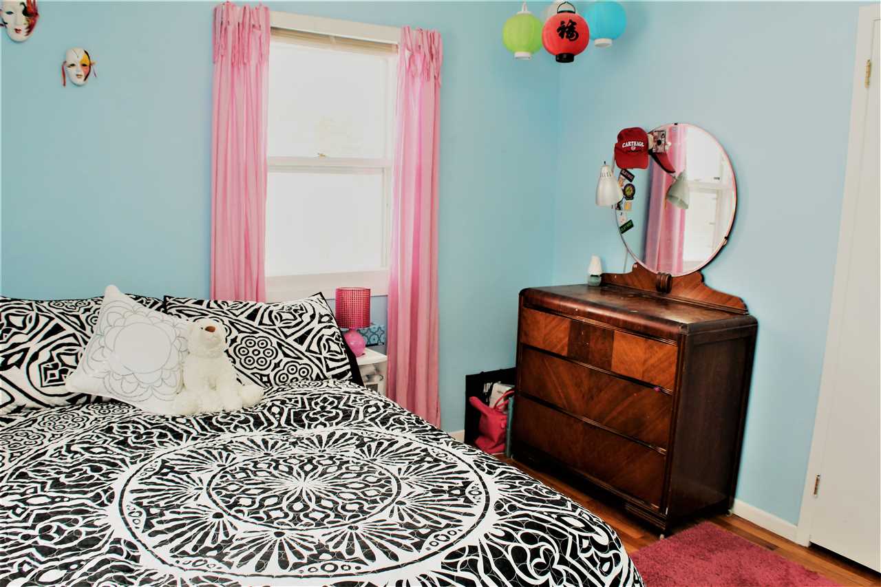 10619 Grover Oaks Road Roscoe, IL 61073 - Photo 17 of 24 a bedroom with a bed and a chandelier