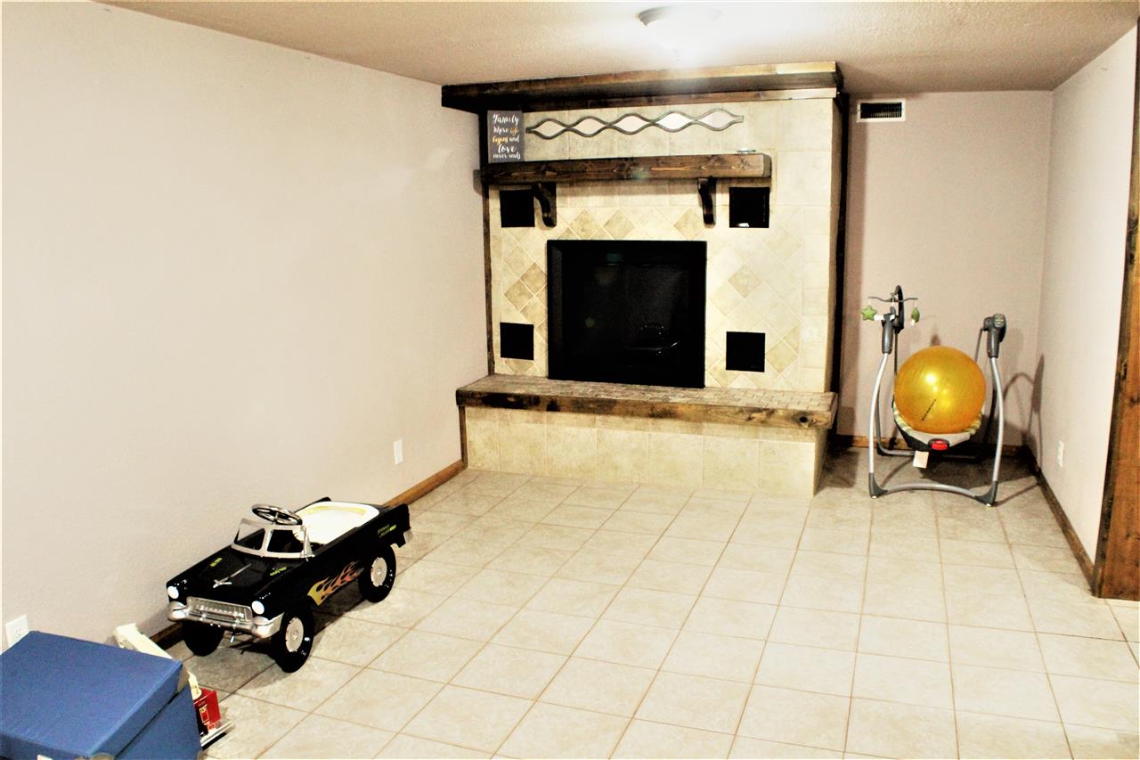 10619 Grover Oaks Road Roscoe, IL 61073 - Photo 20 of 24 a living room with furniture and a fireplace