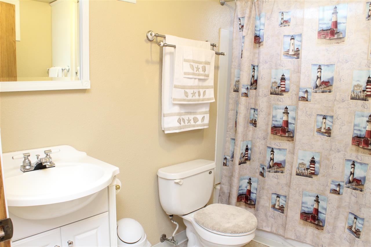 10619 Grover Oaks Road Roscoe, IL 61073 - Photo 22 of 24 a white toilet sitting next to a bathroom sink