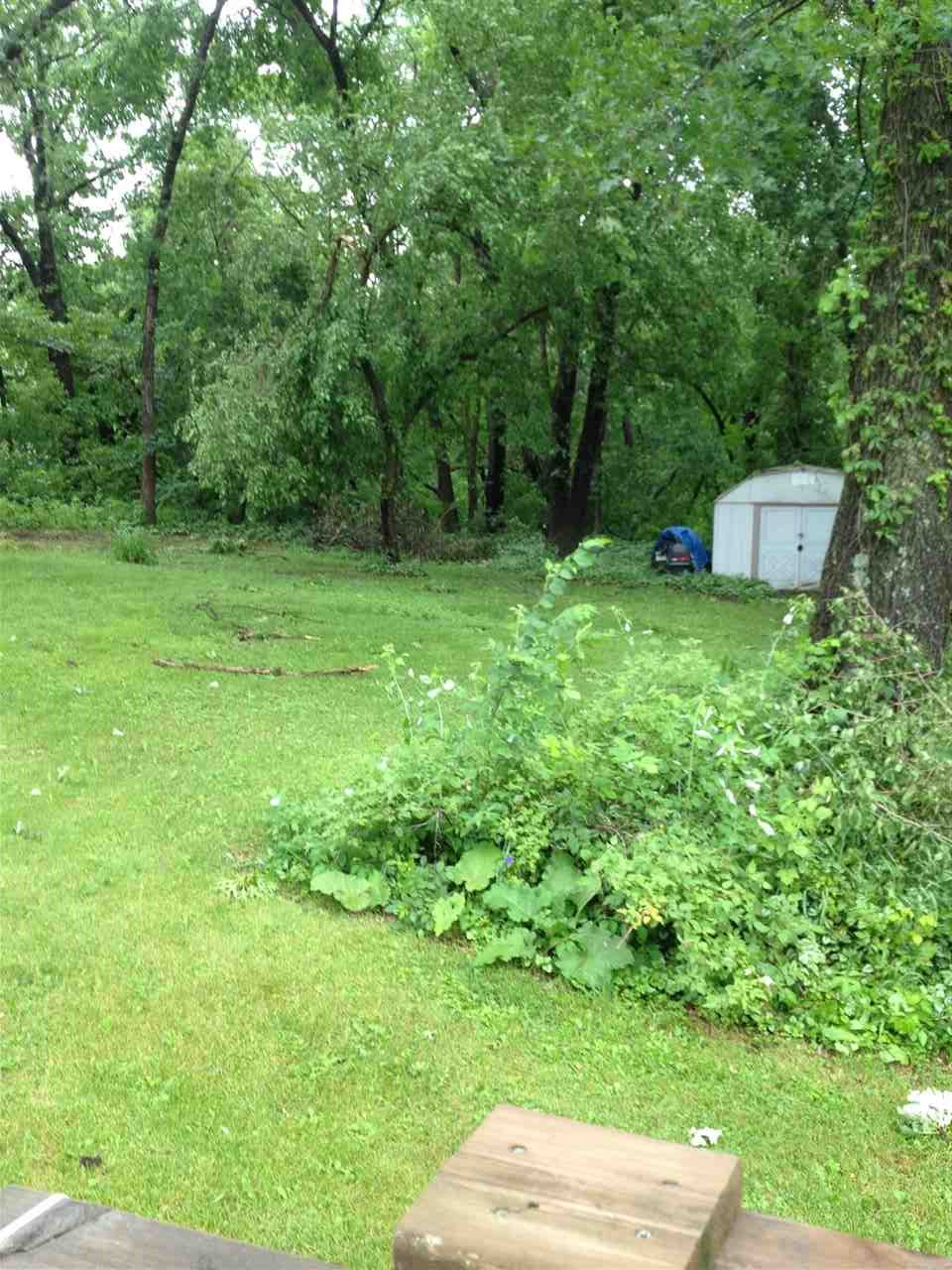 10619 Grover Oaks Road Roscoe, IL 61073 - Photo 5 of 24 a backyard of a house with lots of green space
