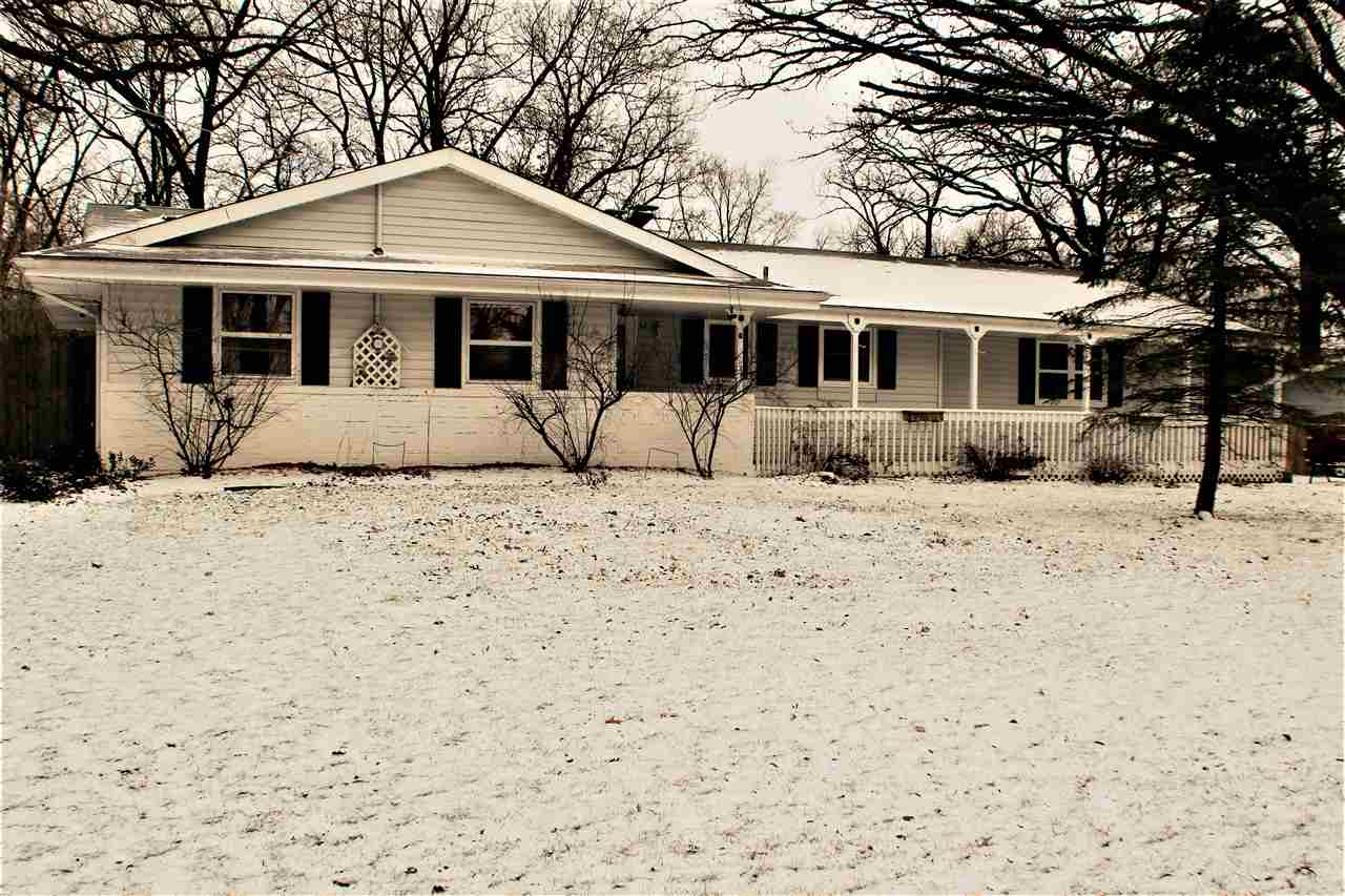 10619 Grover Oaks Road Roscoe, IL 61073 - Photo 6 of 24 a front view of a house with a yard covered in snow