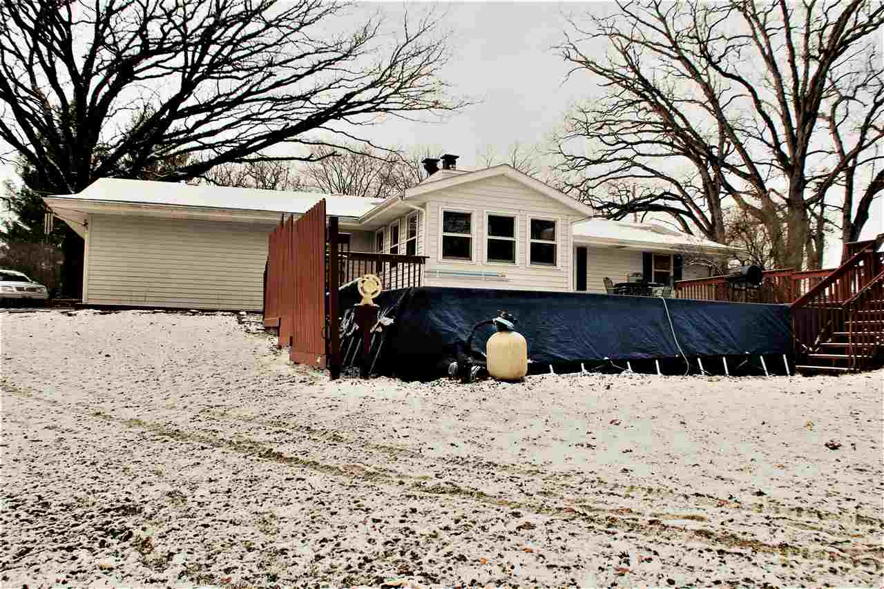 10619 Grover Oaks Road Roscoe, IL 61073 - Photo 7 of 24 a front view of a house with a yard covered with snow