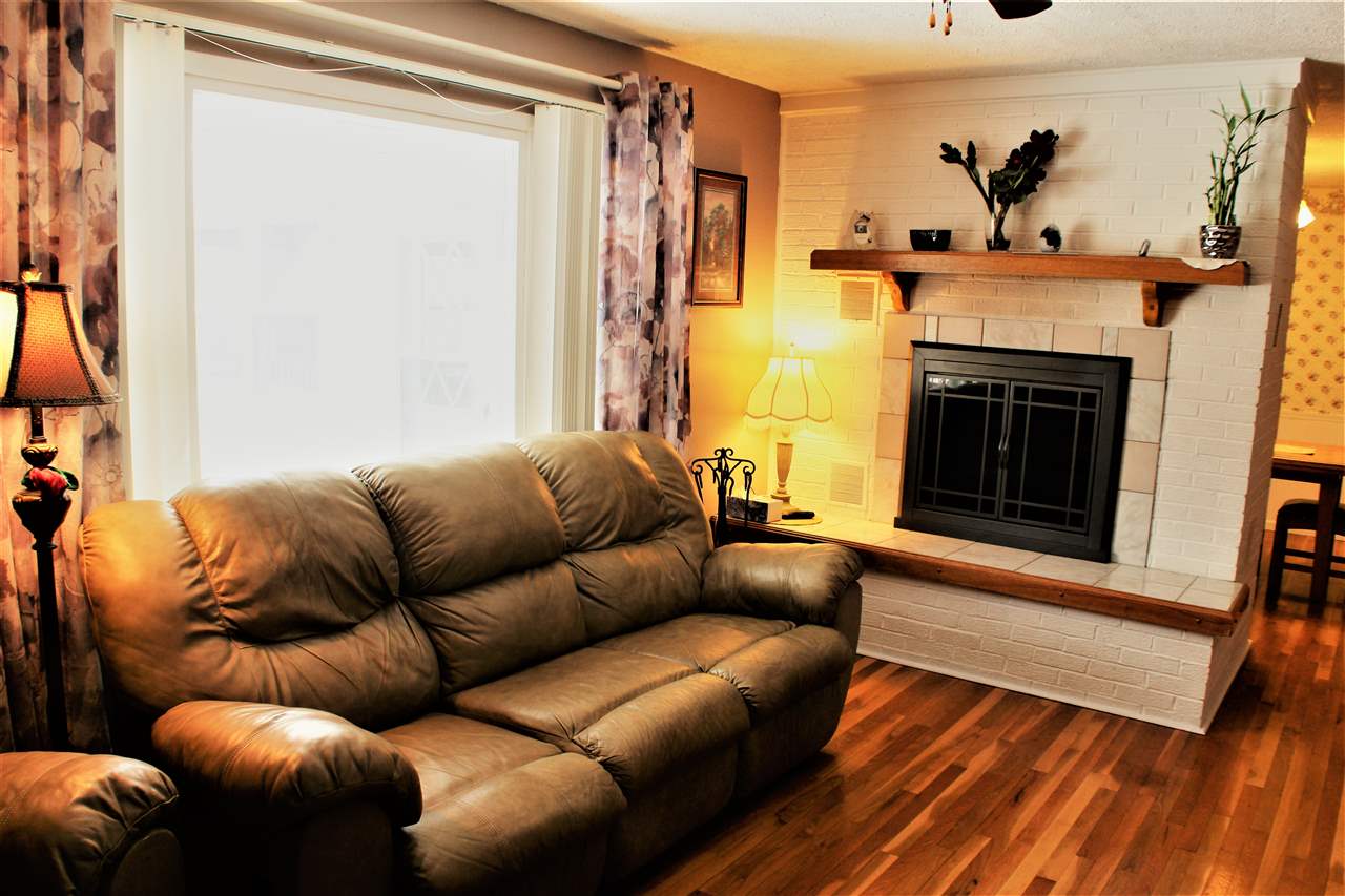 10619 Grover Oaks Road Roscoe, IL 61073 - Photo 9 of 24 a living room with furniture and a fireplace