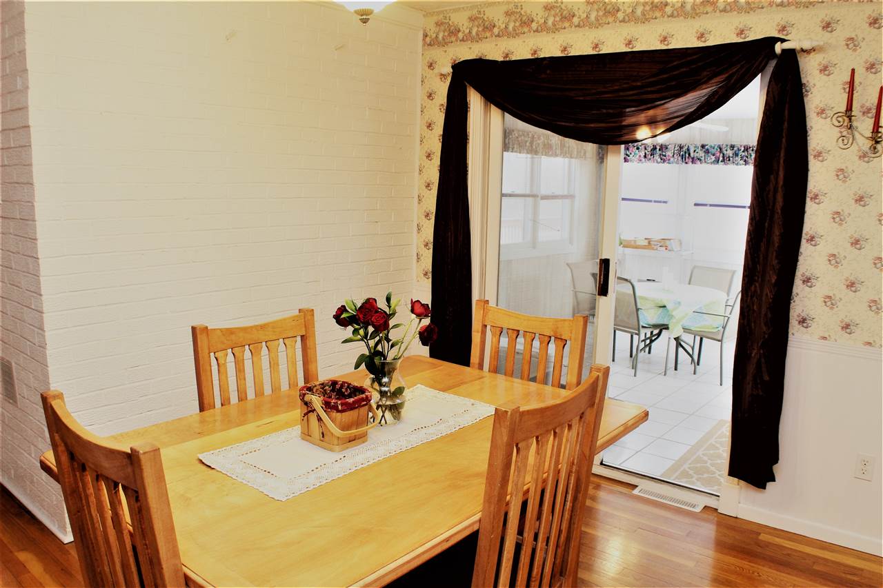 10619 Grover Oaks Road Roscoe, IL 61073 - Photo 10 of 24 a view of table and chair with wooden floor