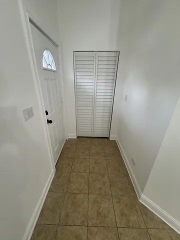 a view of a room with wooden floor and a window