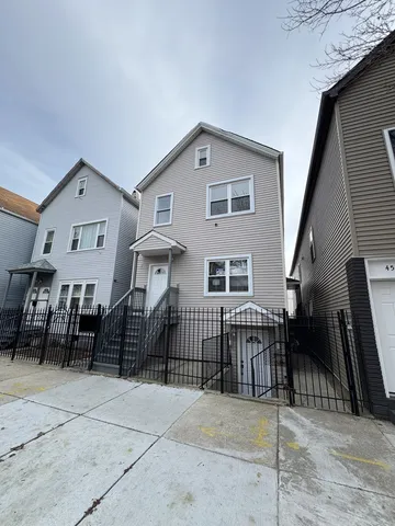 a view of a house with iron fence