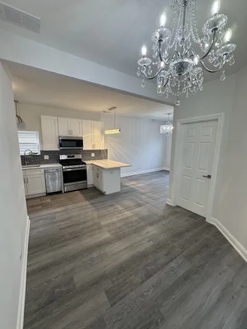a open kitchen with kitchen island a sink stainless steel appliances and cabinets