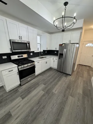 a kitchen with stainless steel appliances a refrigerator a stove a microwave and cabinets