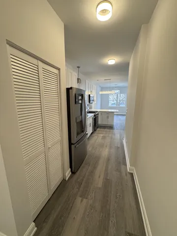 a view of a refrigerator in kitchen and wooden floor