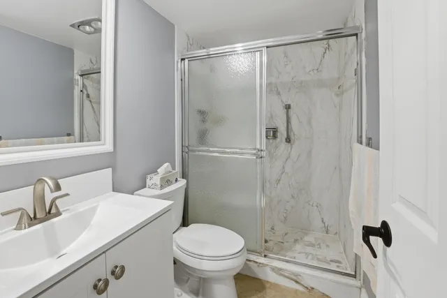 a bathroom with a sink toilet and shower
