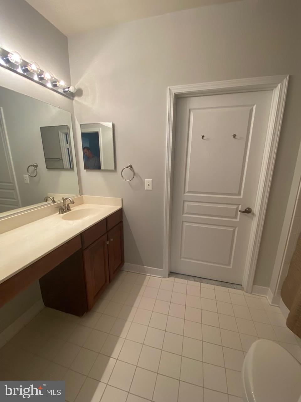 12001 Market Street, Unit 206 Reston, VA 20190 - Photo 17 of 22 Primary Full Bathroom to Laundry Area