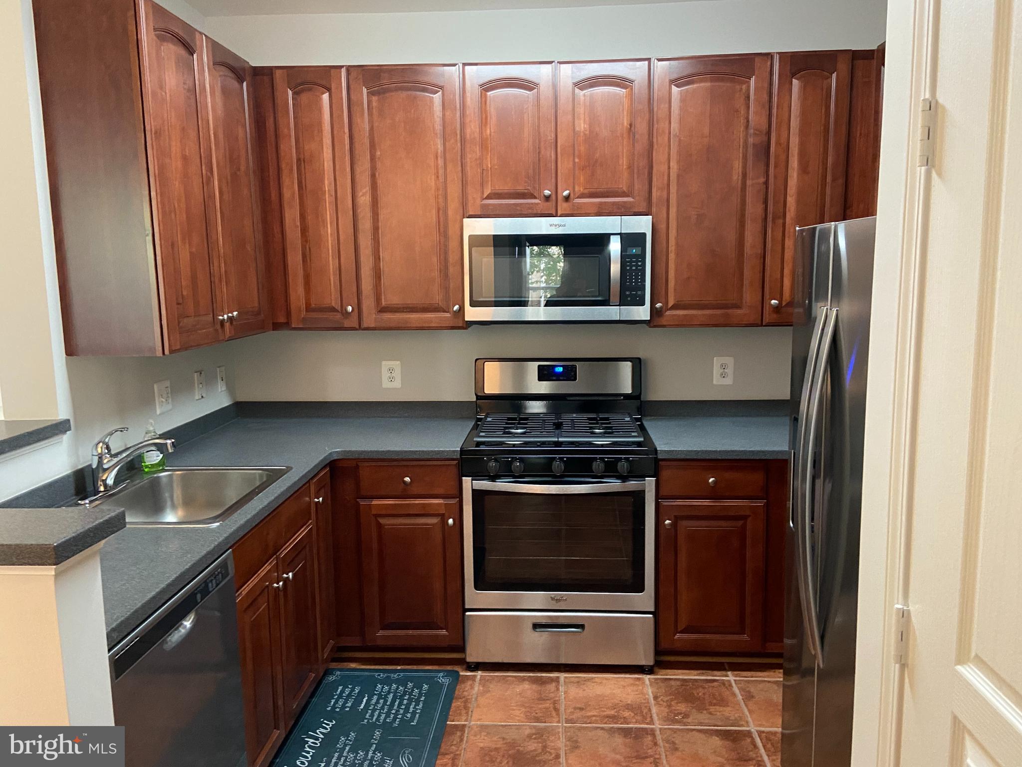 12001 Market Street, Unit 206 Reston, VA 20190 - Photo 2 of 22 Elegant Cherry Cabinetry with New SS Appliances!!