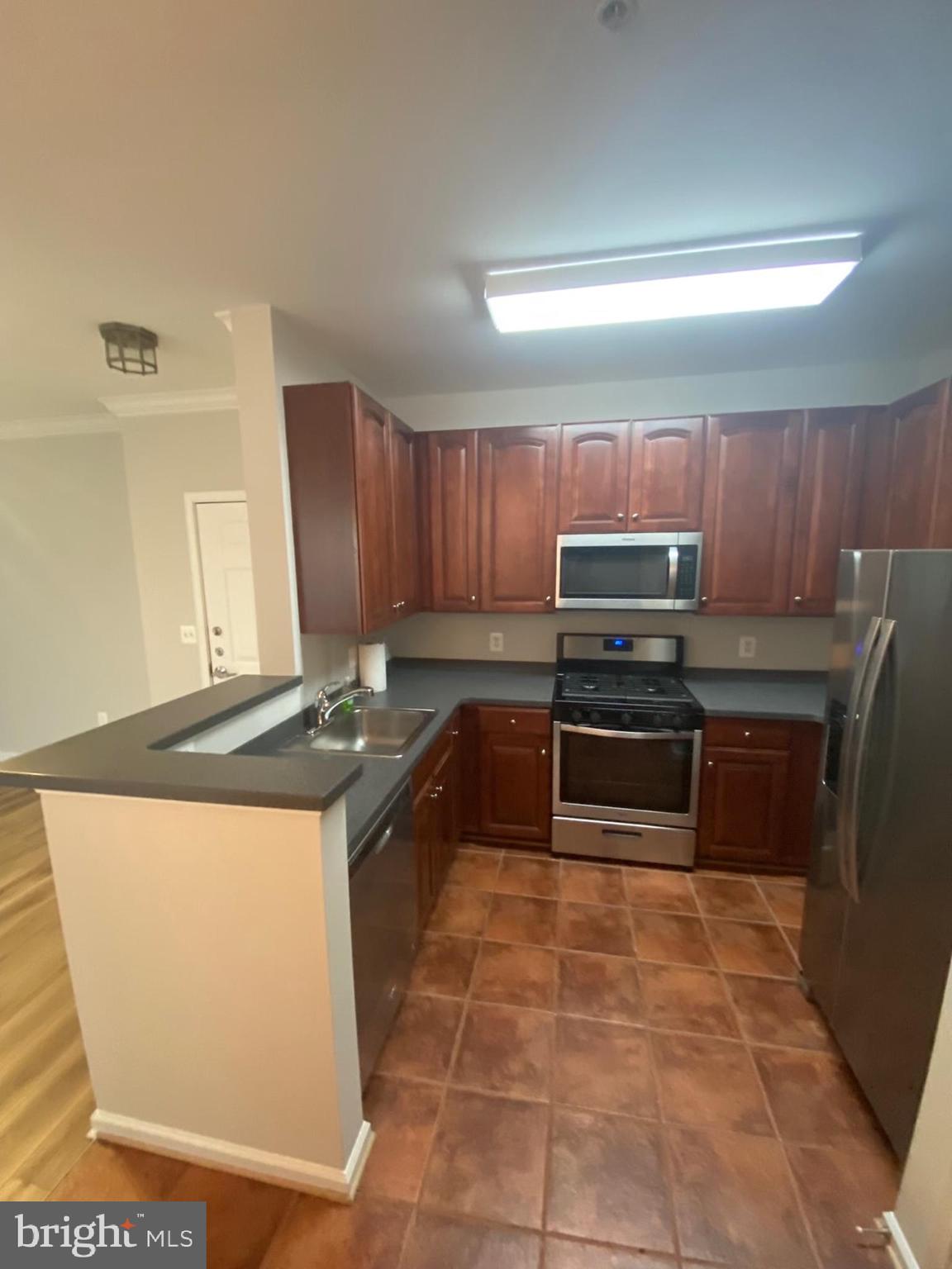 12001 Market Street, Unit 206 Reston, VA 20190 - Photo 3 of 22 Breakfast Bar w/ NEW SS Appliances!!