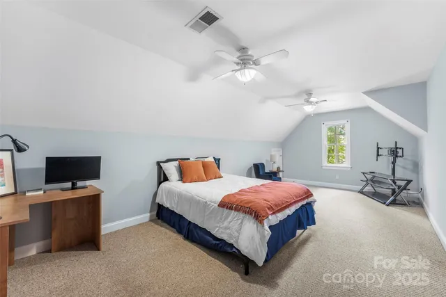 a bedroom with a bed and a tv on table