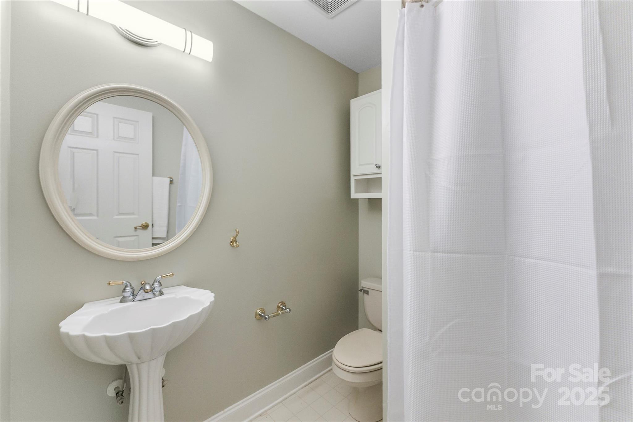104 Tallwood Drive Shelby, NC 28152 - Photo 25 of 41 a bathroom with a toilet a sink and mirror