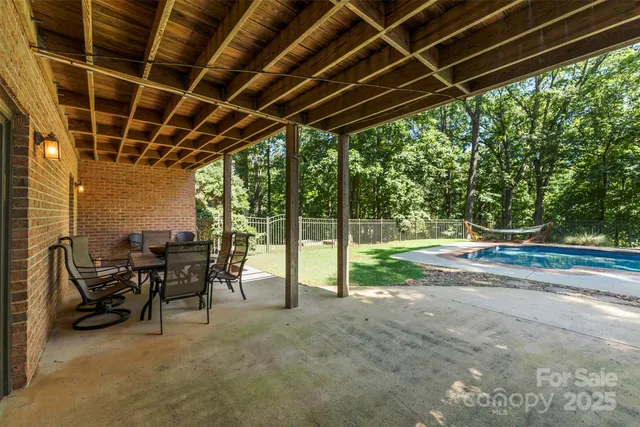 a view of a porch with furniture and garden