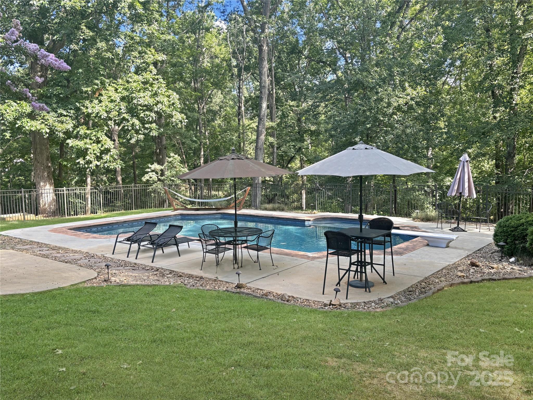 104 Tallwood Drive Shelby, NC 28152 - Photo 37 of 41 a view of patio with table and chairs under an umbrella