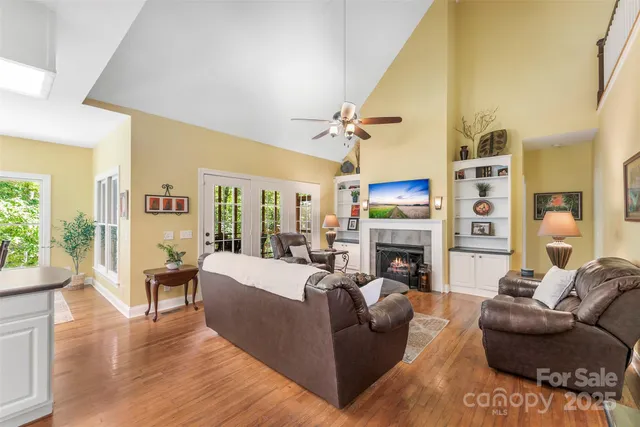 a living room with fireplace furniture and a wooden floor