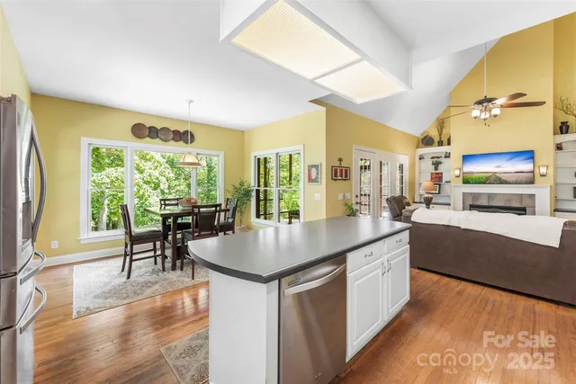 a kitchen with counter top space and wooden floor