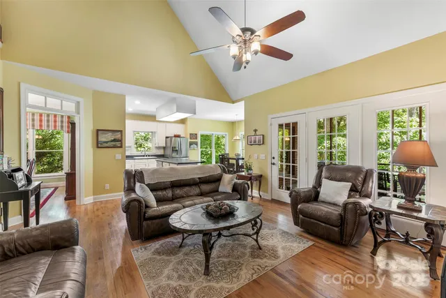 a living room with furniture a table and a large window