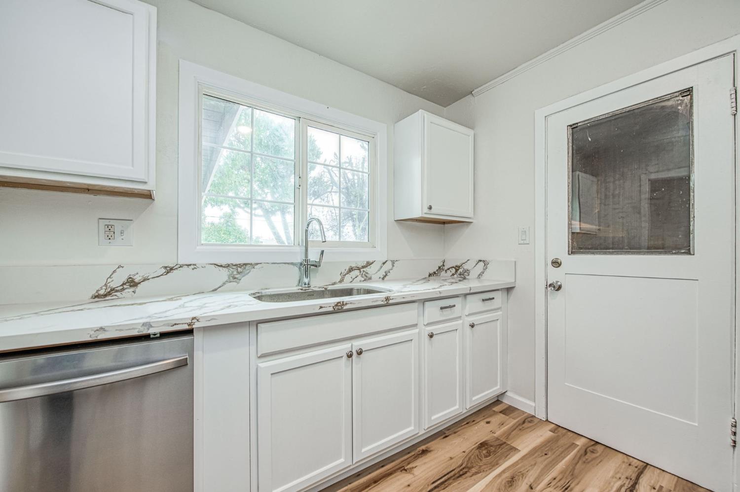 517 Rotan Avenue Madera, CA 93637 - Photo 12 of 32 a kitchen with a sink stove and cabinets