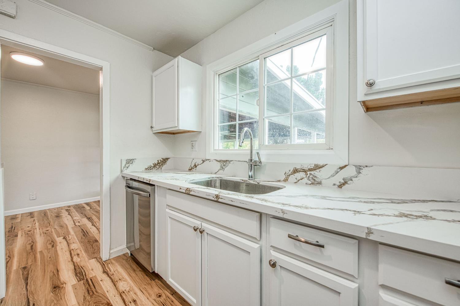 517 Rotan Avenue Madera, CA 93637 - Photo 13 of 32 a kitchen with a sink and a window