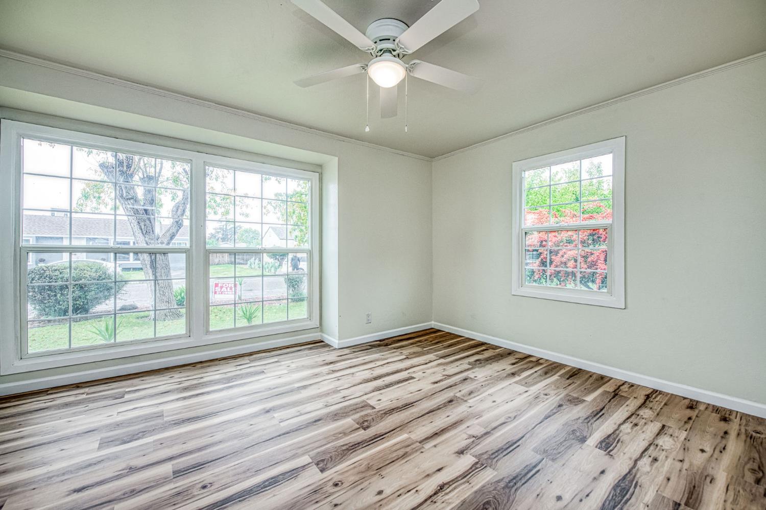 517 Rotan Avenue Madera, CA 93637 - Photo 15 of 32 a view of an empty room with wooden floor and a window