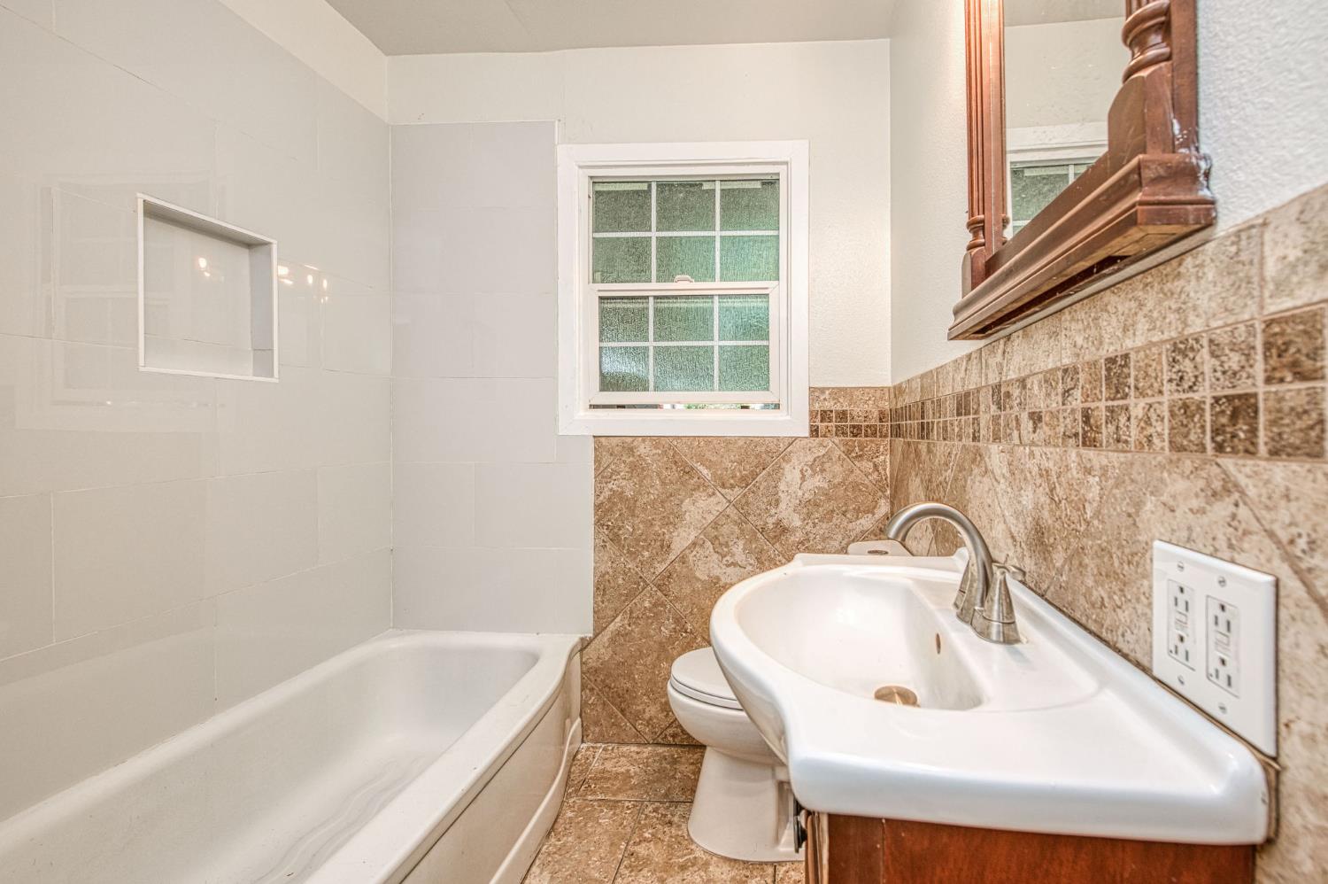 517 Rotan Avenue Madera, CA 93637 - Photo 17 of 32 a bathroom with a sink and a bathtub