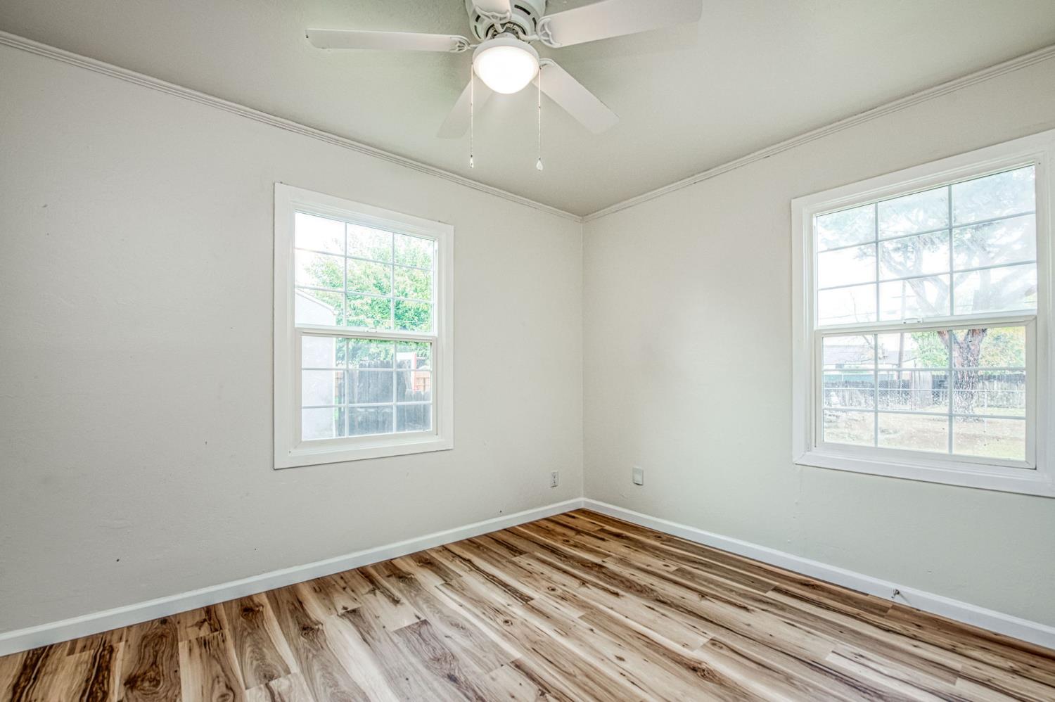 517 Rotan Avenue Madera, CA 93637 - Photo 18 of 32 a view of an empty room with wooden floor and a window